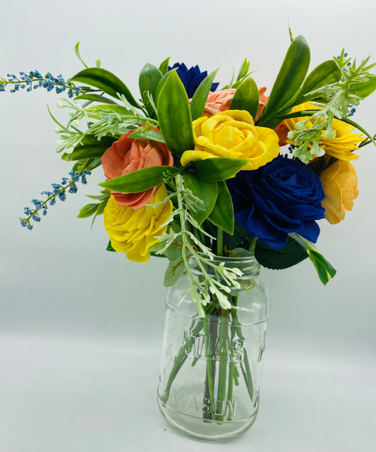 Multi color arrangement on glass jar vase