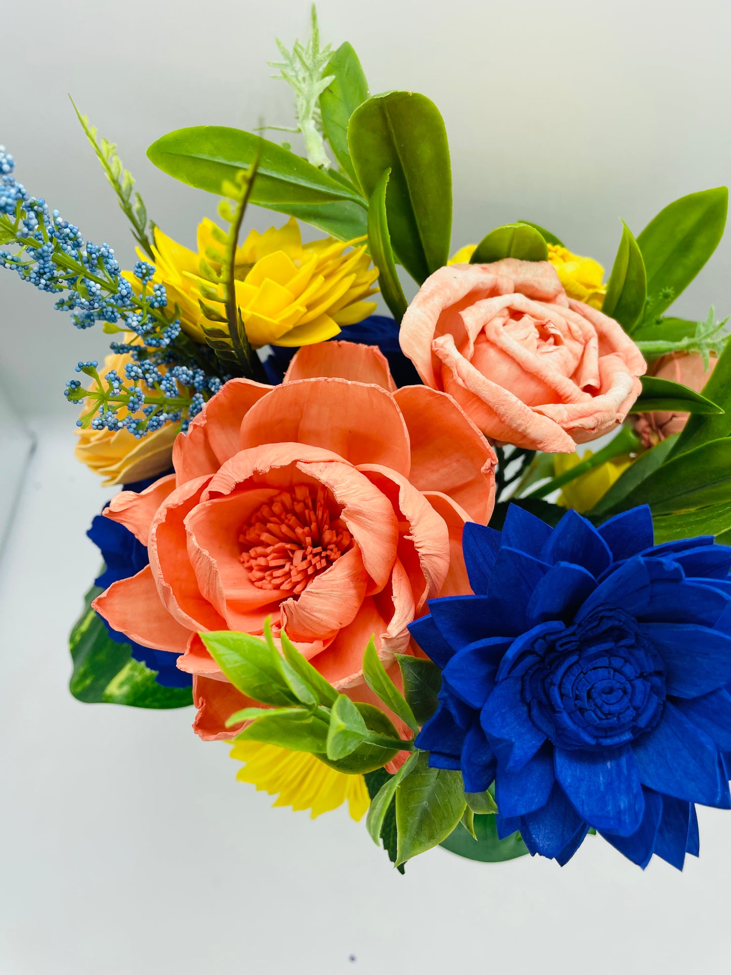 Multi color arrangement on glass jar vase