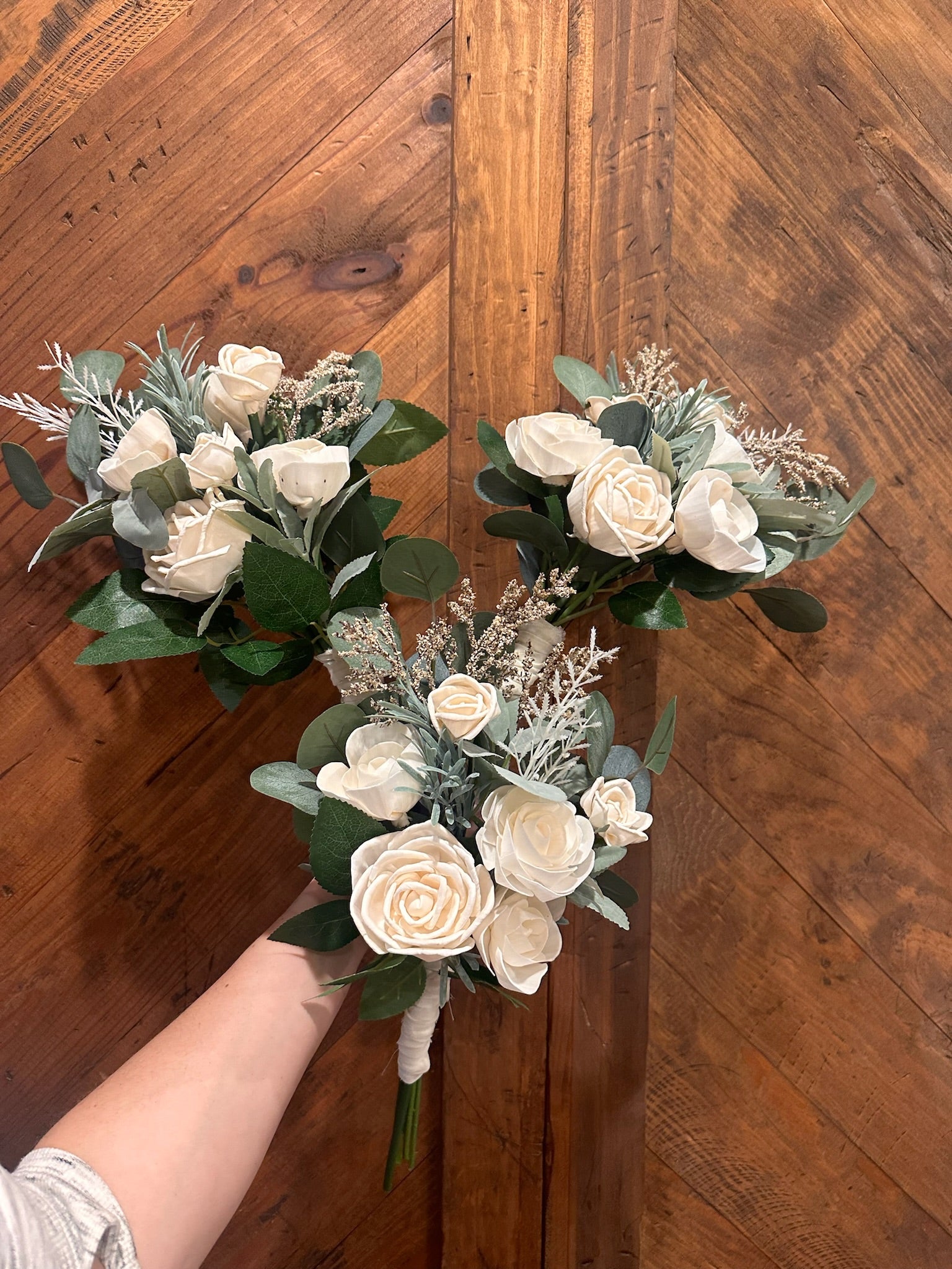 Three bridesmaid bouquets in ivory wood flowers with premium faux greenery