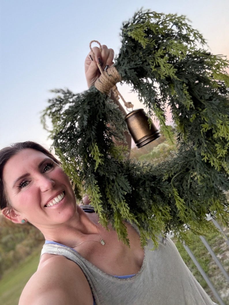 Cedar greenery wreath bronze bell detail