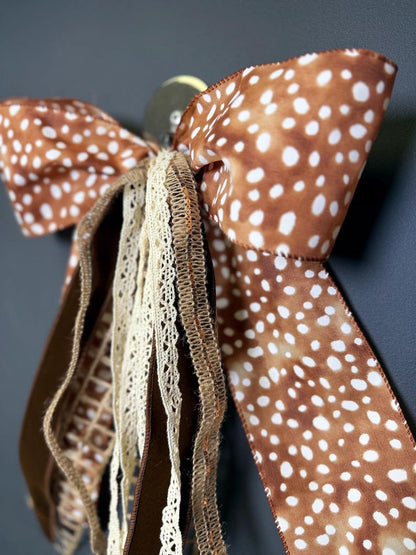 Spotted axis print wreath bow metal fastener detail