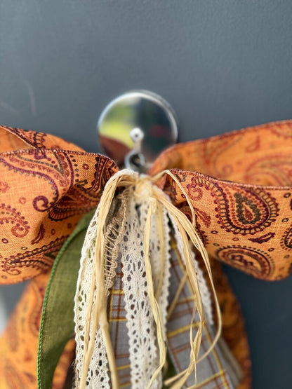 Rust paisley wreath bow metal hook detail